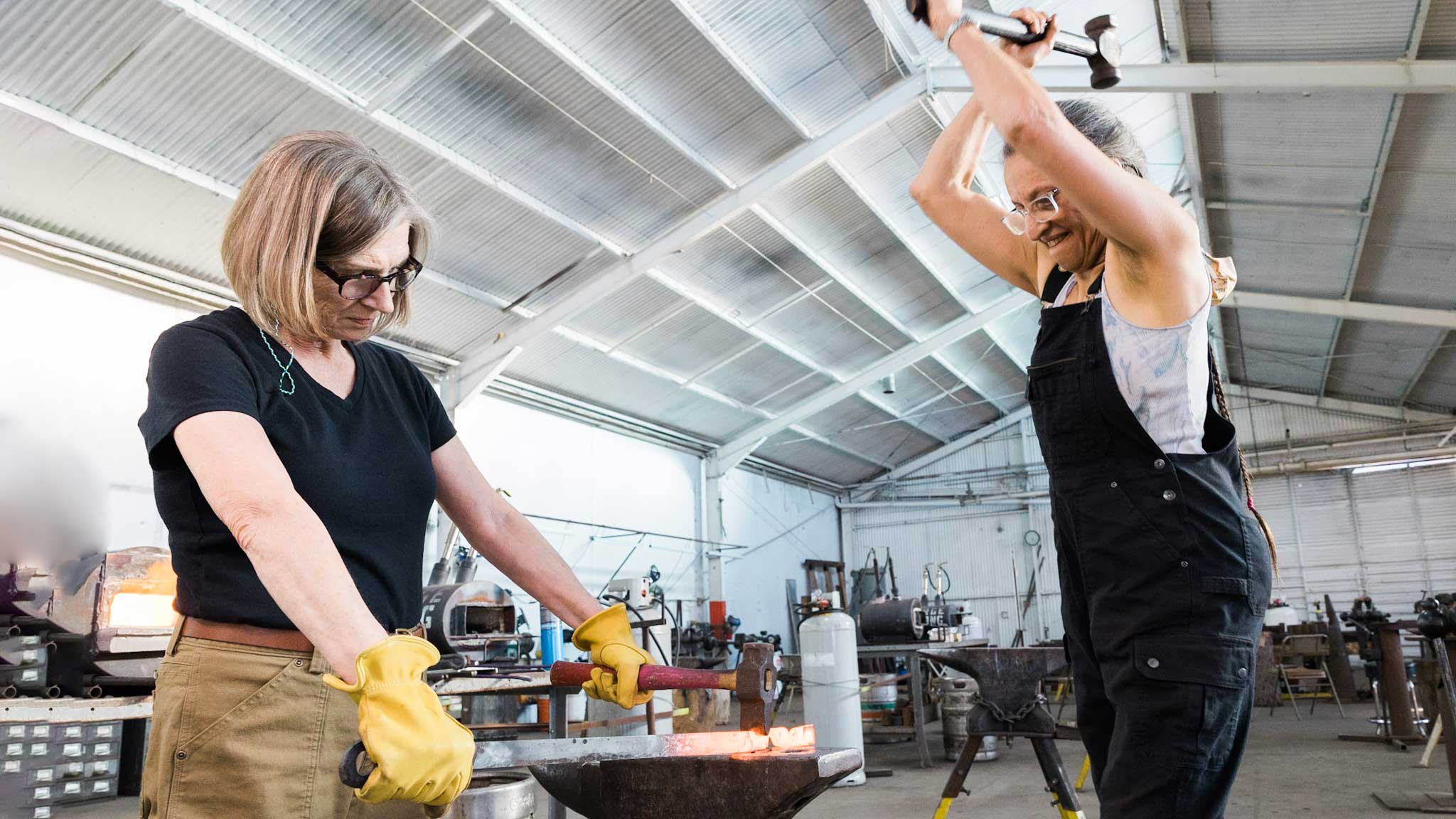 Heather McLarty and Mary Jane Verniere at Adam's Forge demonstrating blacksmithing for the Craft Video Dictionary CVD