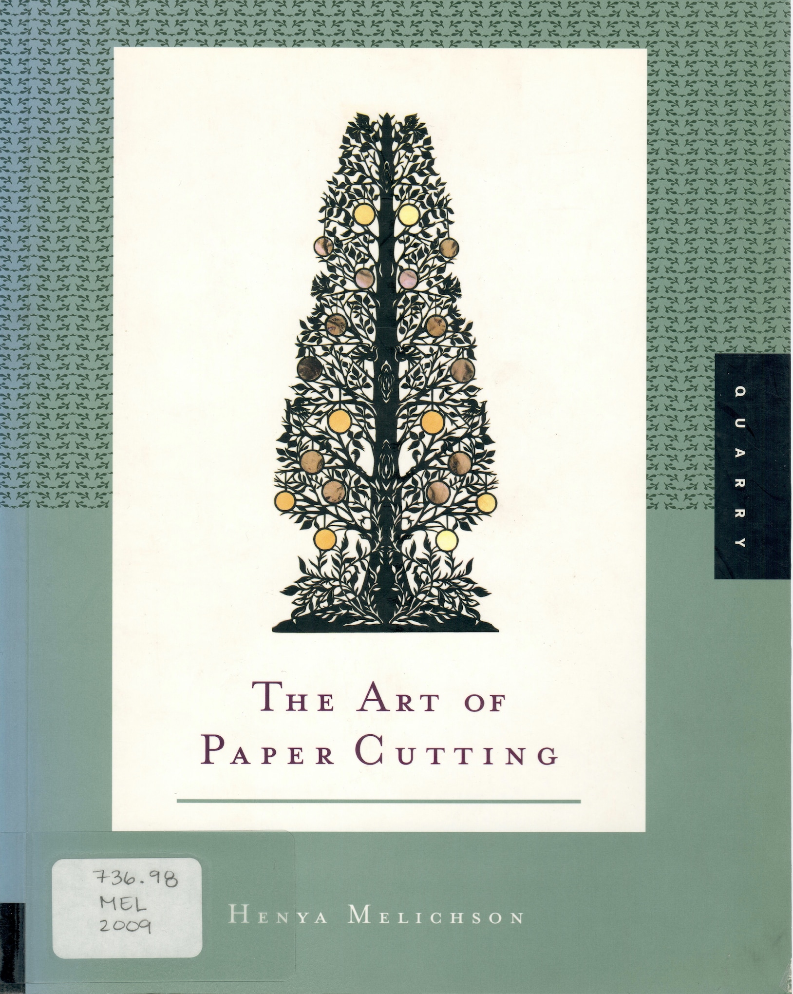 Book cover for "The Art of Paper Cutting" green background with an ornate paper-cut silhouette of a tree bearing fruit